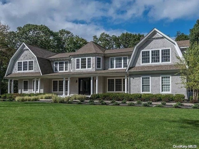 view of front of house with a porch and a front lawn