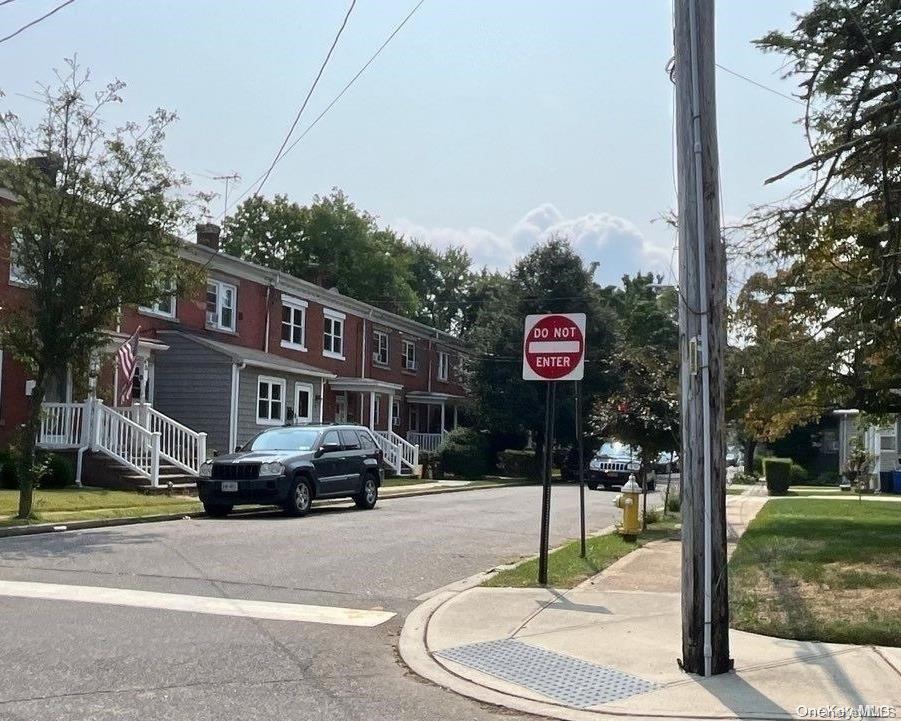 5 Columbia St, Farmingdale, NY 11735 - view of asphalt street featuring curbs, traffic signs, and sidewalks