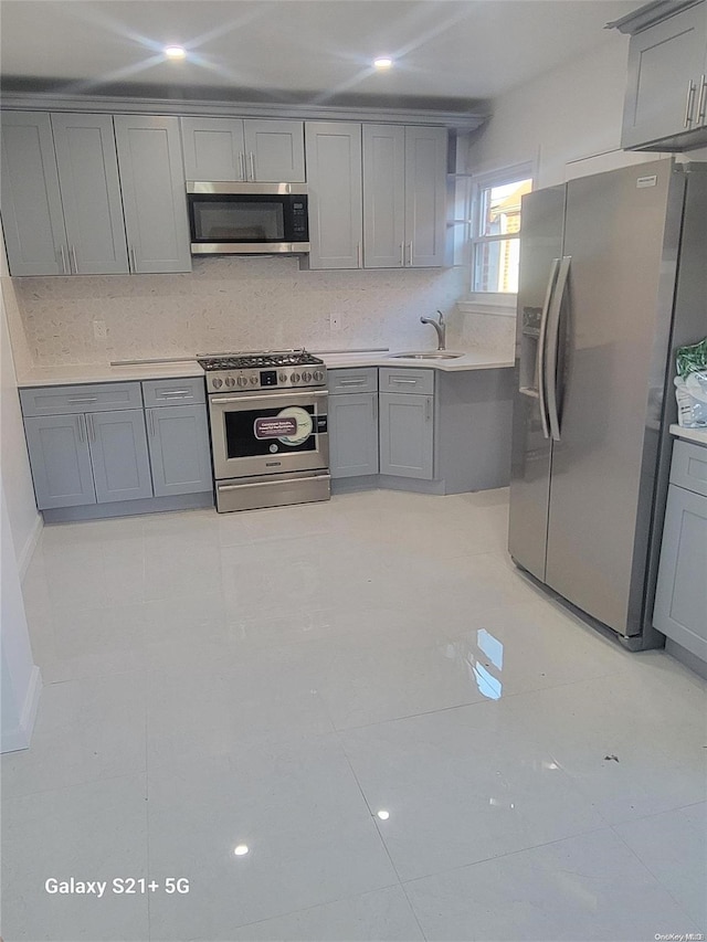 kitchen featuring gray cabinets and stainless steel appliances