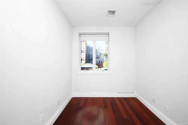 spare room with dark wood-type flooring