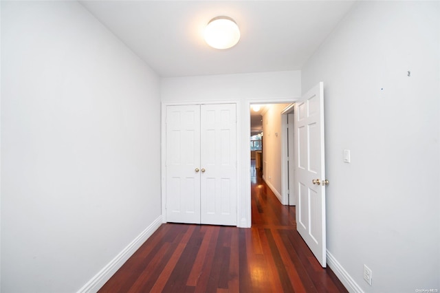 hall with dark hardwood / wood-style flooring