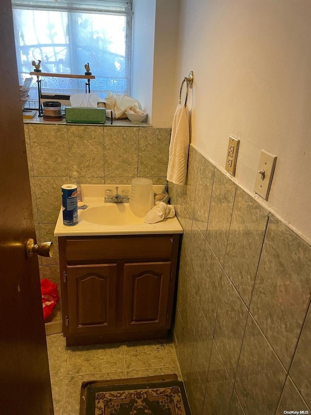 bathroom with vanity and tile walls