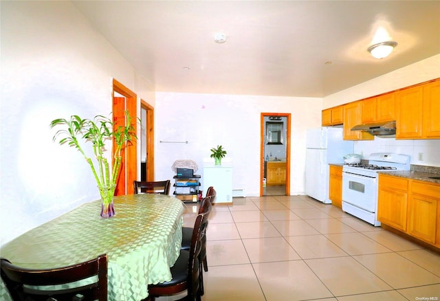 kitchen with decorative backsplash, light tile patterned flooring, white appliances, and a baseboard heating unit