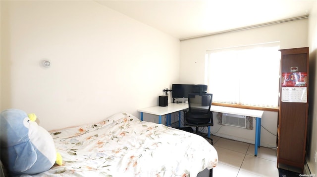 bedroom featuring a wall mounted AC and light tile patterned flooring