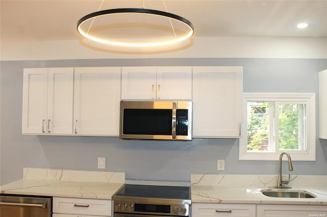 kitchen featuring white cabinetry, sink, and appliances with stainless steel finishes