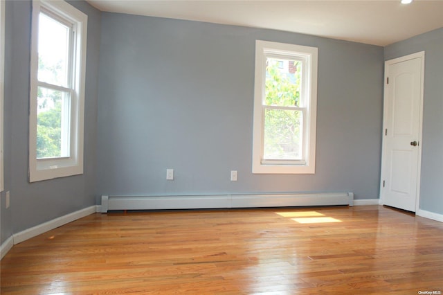 spare room with light hardwood / wood-style flooring and a baseboard radiator