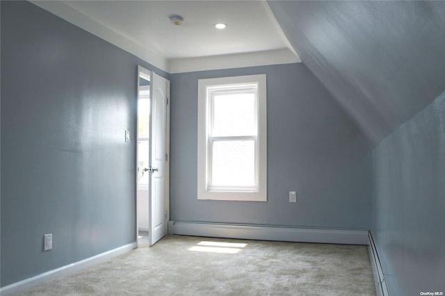 additional living space with light carpet, baseboard heating, and lofted ceiling