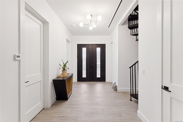 foyer entrance with light hardwood / wood-style flooring