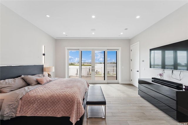 bedroom featuring access to exterior, french doors, and light hardwood / wood-style floors