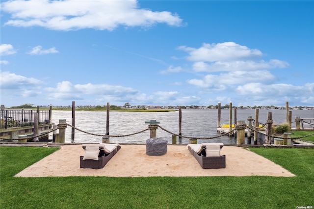 view of dock featuring a water view and a yard