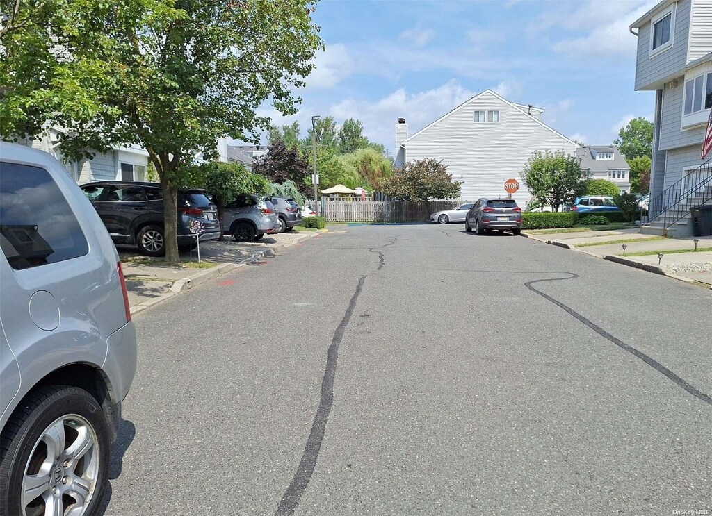 110F Dinsmore St Unit 110F, Staten Island, NY 10314 - view of asphalt road featuring curbs, traffic signs, and a residential view