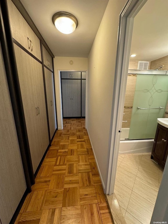 corridor with light parquet floors