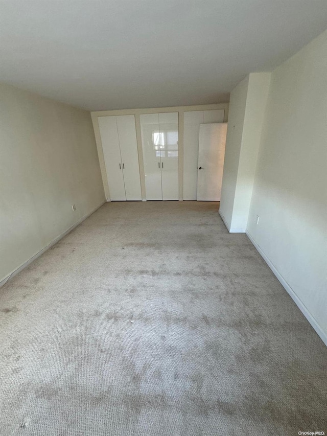 unfurnished bedroom with light carpet