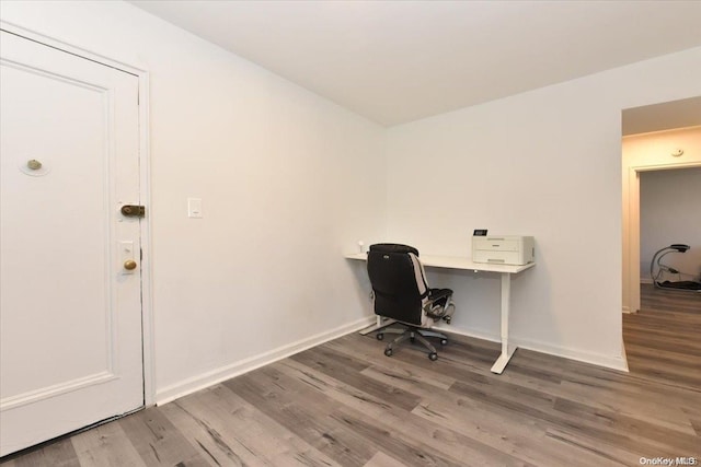 unfurnished office featuring hardwood / wood-style floors