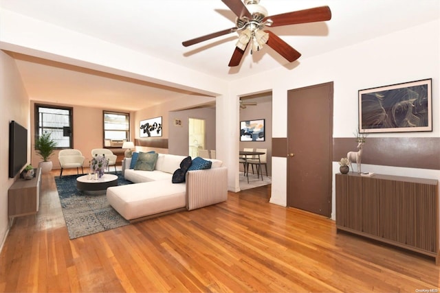 living room with radiator, ceiling fan, and light hardwood / wood-style floors