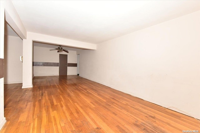 unfurnished room with ceiling fan and wood-type flooring