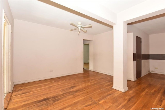 spare room with ceiling fan and wood-type flooring