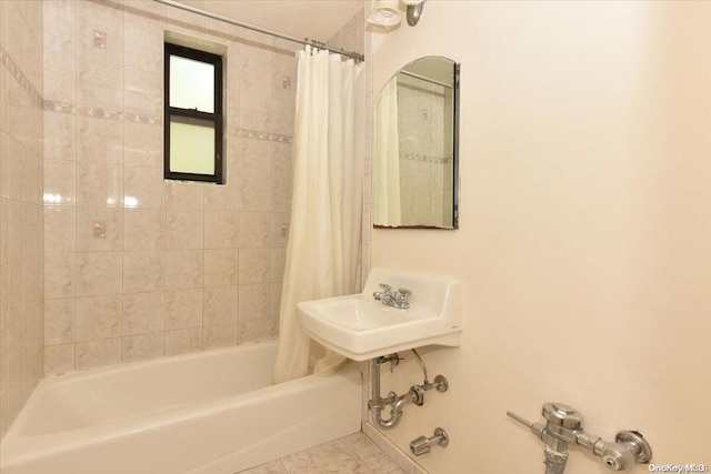 bathroom featuring tile patterned flooring, shower / bathtub combination with curtain, and sink