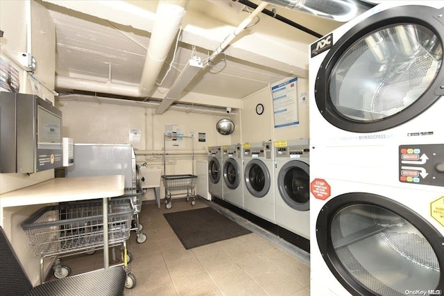 washroom featuring stacked washer and dryer and sink