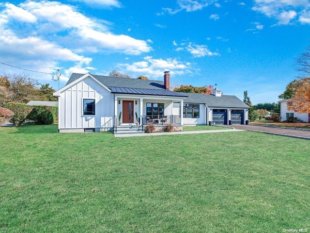 exterior space featuring a front yard, a garage, and covered porch