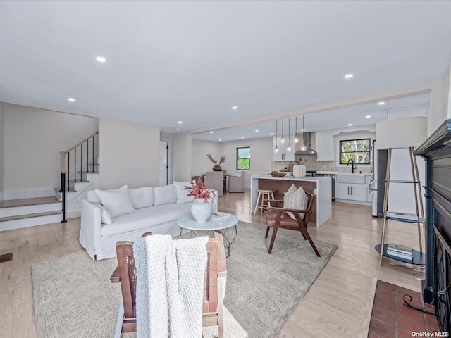 living room featuring light hardwood / wood-style floors and sink