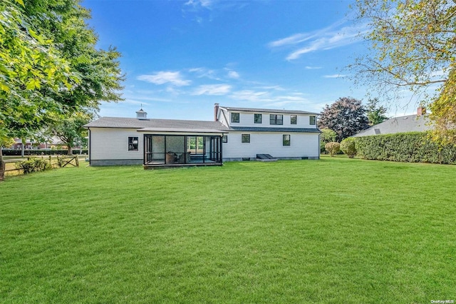 rear view of house with a lawn