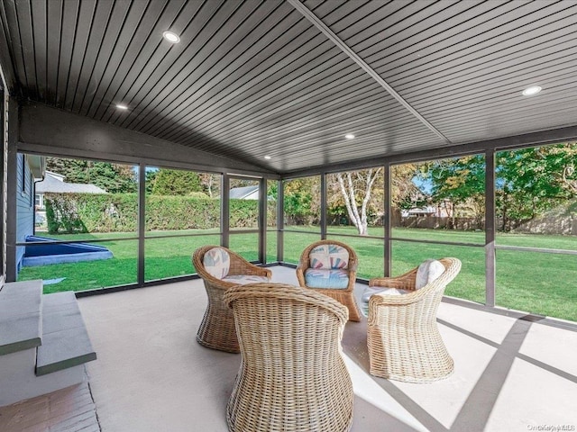 sunroom featuring plenty of natural light, wood ceiling, and vaulted ceiling