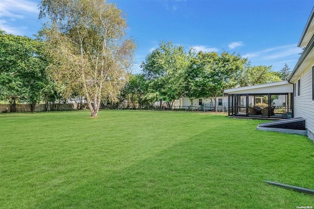 view of yard featuring a sunroom