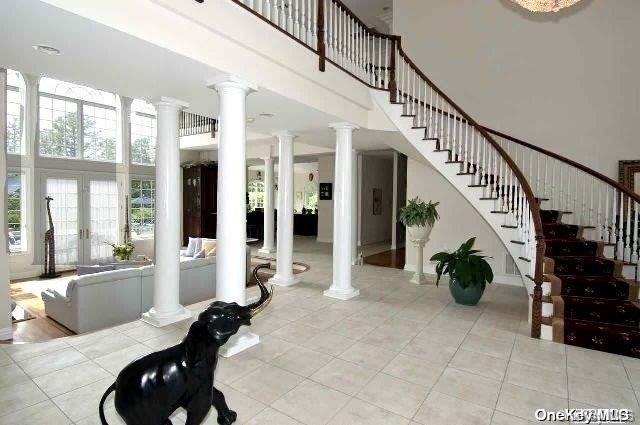 interior space featuring french doors and a high ceiling