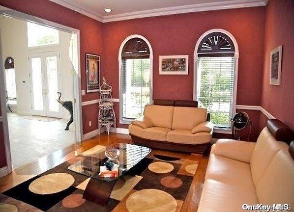 living room with ornamental molding and french doors