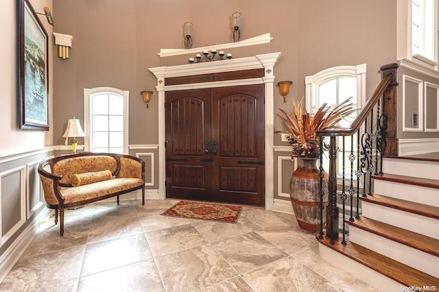 entrance foyer with a towering ceiling and plenty of natural light