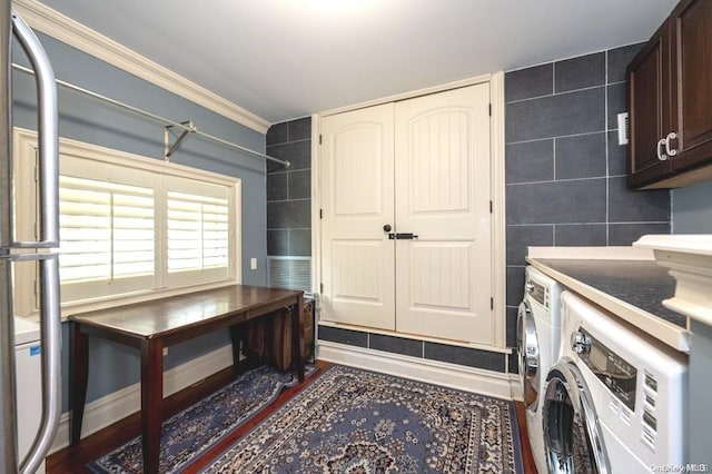 laundry room featuring cabinets, ornamental molding, washer and clothes dryer, dark wood-type flooring, and tile walls