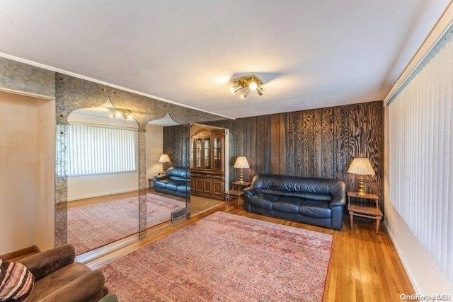 living room featuring hardwood / wood-style floors and crown molding