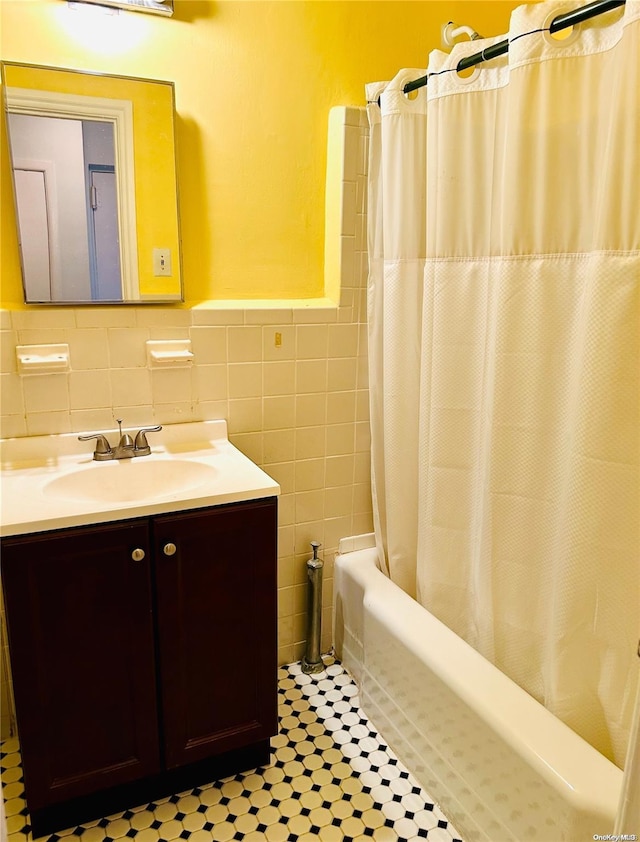 bathroom featuring vanity and tile walls