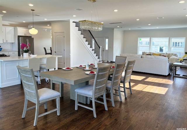 dining space with dark hardwood / wood-style flooring and a chandelier