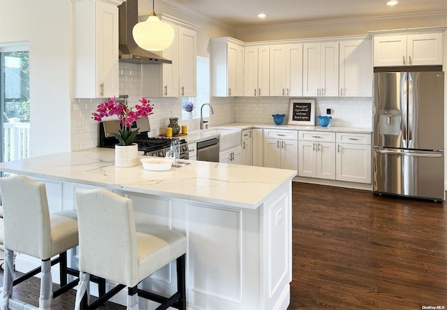 kitchen featuring kitchen peninsula, white cabinetry, hanging light fixtures, and appliances with stainless steel finishes