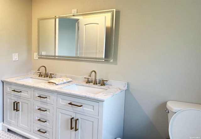 bathroom featuring tile patterned floors, vanity, and toilet