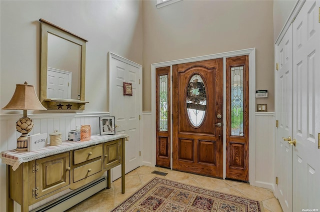 foyer entrance featuring light tile patterned floors and a baseboard heating unit