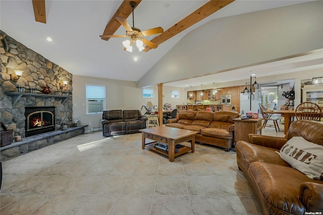 living room with a fireplace, beam ceiling, plenty of natural light, and ceiling fan