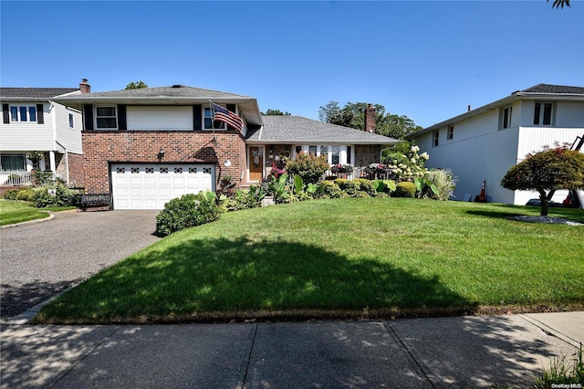 split level home with a front yard and a garage