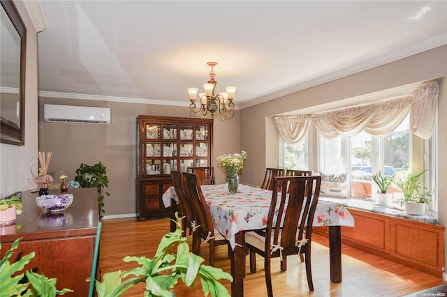 dining room featuring a wall mounted air conditioner, light wood-type flooring, crown molding, and a notable chandelier