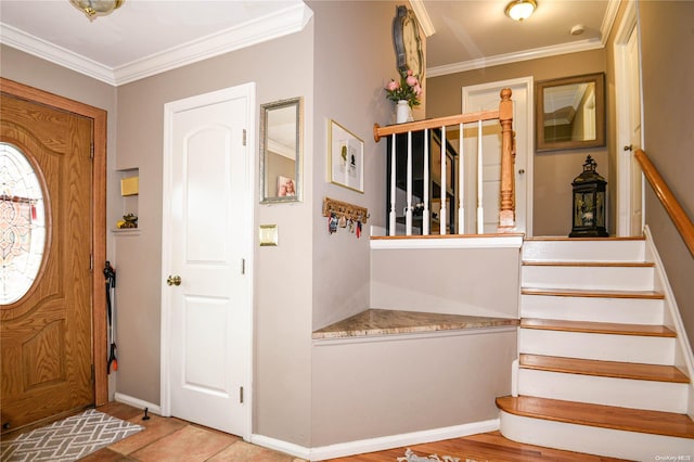 foyer with light hardwood / wood-style floors and ornamental molding