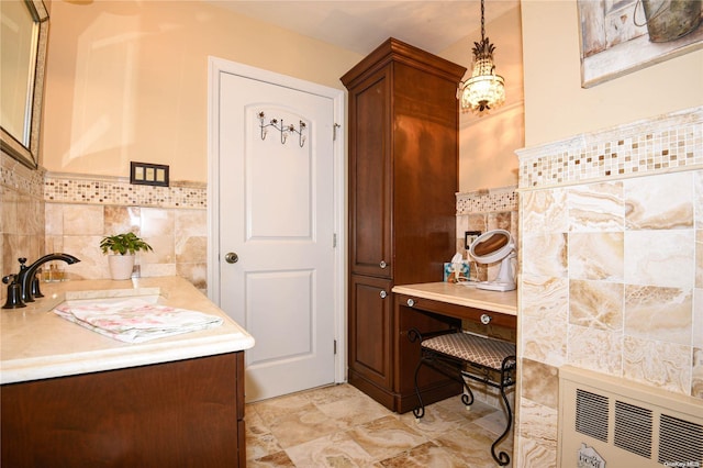 bathroom with radiator heating unit, vanity, and tile walls