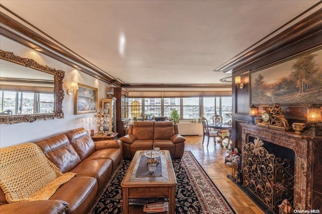 living room featuring a brick fireplace, a wealth of natural light, parquet floors, and ornamental molding