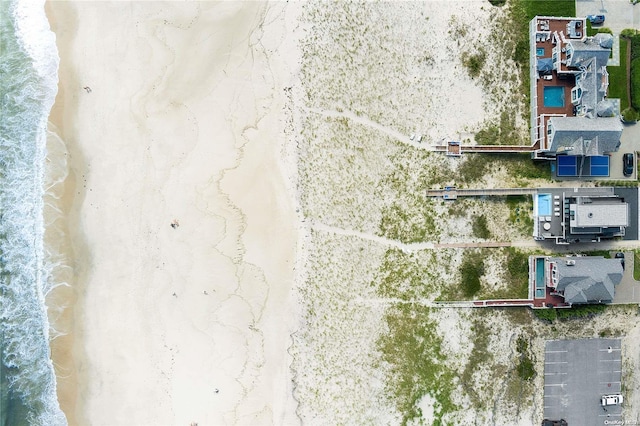 bird's eye view featuring a water view and a view of the beach