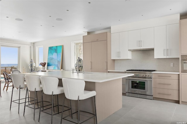 773 Dune Rd, Westhampton Beach, NY 11978 - kitchen featuring stainless steel appliances, a breakfast bar area, light countertops, and modern cabinets