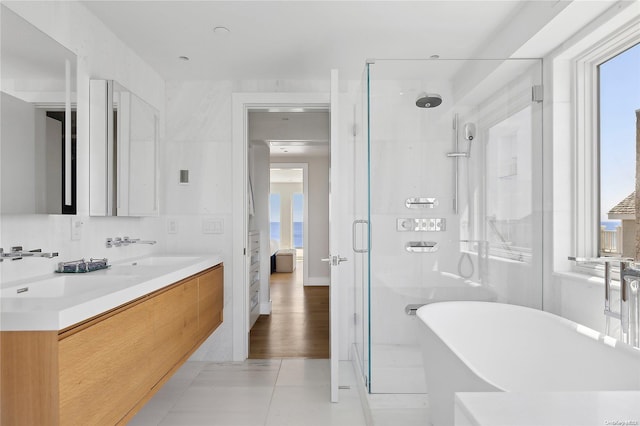 773 Dune Rd, Westhampton Beach, NY 11978 - ensuite bathroom with a freestanding bath, a shower stall, double vanity, and healthy amount of natural light