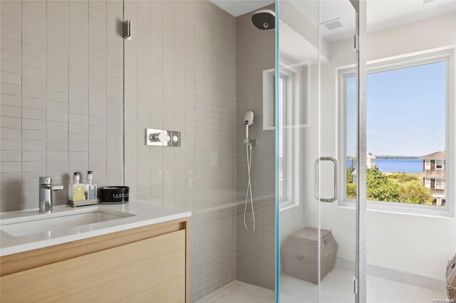 773 Dune Rd, Westhampton Beach, NY 11978 - bathroom with a stall shower, vanity, and a water view