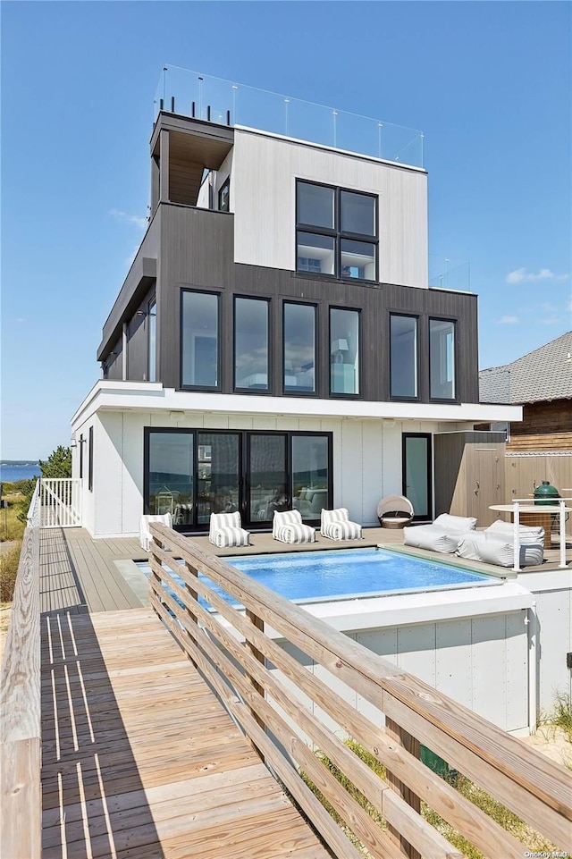 773 Dune Rd, Westhampton Beach, NY 11978 - back of property with an outdoor pool and a balcony