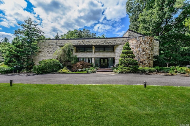 view of front facade featuring a front yard and french doors